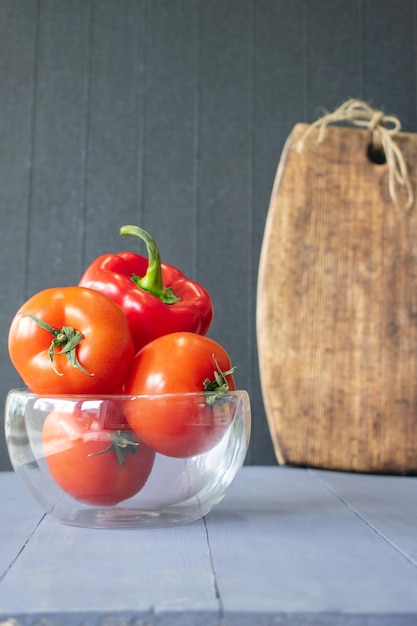 Vegetables on a wooden background cooking from tomatoes and sweet red peppers selective focus