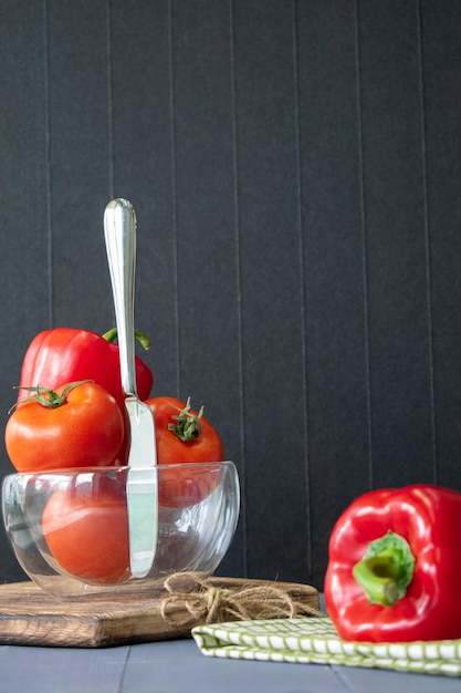 Vegetables on a wooden background cooking from tomatoes and sweet red peppers selective focus