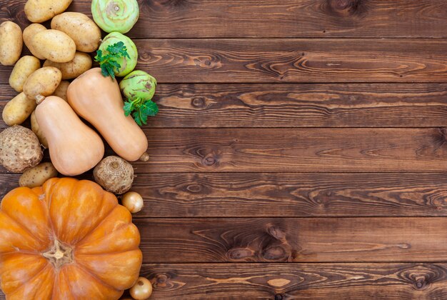 Vegetables on wooden. Pumpkin, zucchini, potatoes, onions and other vegetables