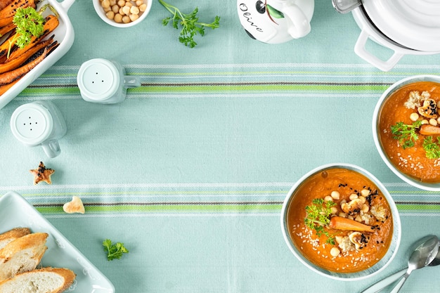 Vegetarian autumn pumpkin and carrot soup with cream seeds and cilantro micro greens Comfort food