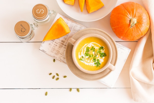 Vegetarian autumn pumpkin cream soup with pumpkin seeds. Top view.