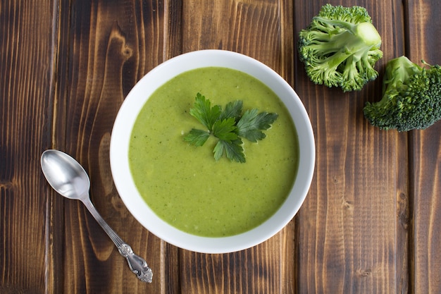 Vegetarian broccoli puree soup in the white bowl