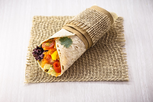 Vegetarian burrito, stuffed with grilled vegetables, healthy food, spicy, tasty