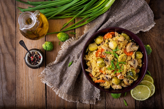 Vegetarian couscous salad with brussels sprouts, mushrooms, carrots and spices