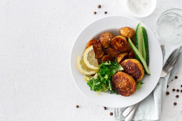 Vegetarian cutlets with new potatoes and salad