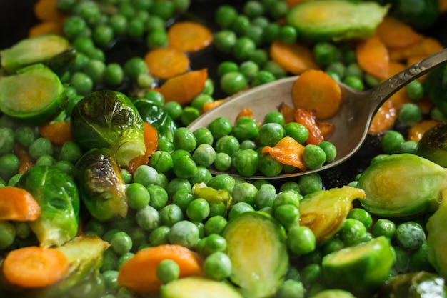 Vegetarian food from fried vegetables, brussels sprouts and carrots