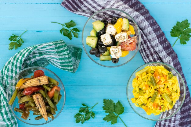 Vegetarian food pilaf and corn salad Greek salad with feta cheese drink with seeds top view