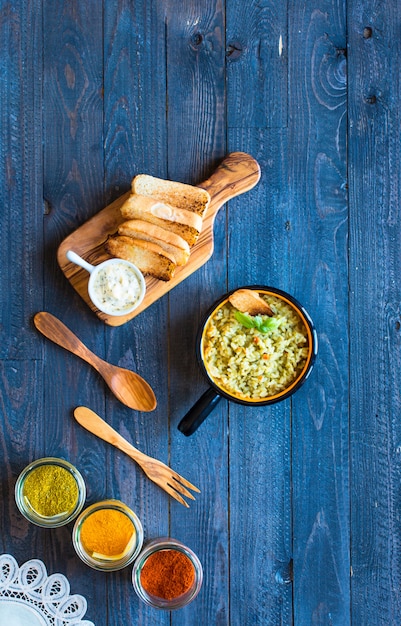 Vegetarian risotto with various vegetables, on wooden rustic table.