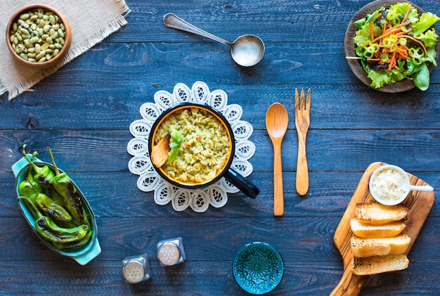 Vegetarian risotto with various vegetables, on wooden rustic table, 