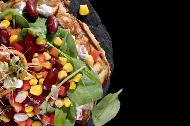 Vegetarian salad on a slate plate full of tasty