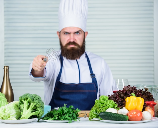 Vegetarian salad with fresh vegetables. Cuisine culinary. Vitamin. Dieting organic food. angry bearded man. chef recipe. Healthy food cooking. Mature hipster with beard. Choosing right.