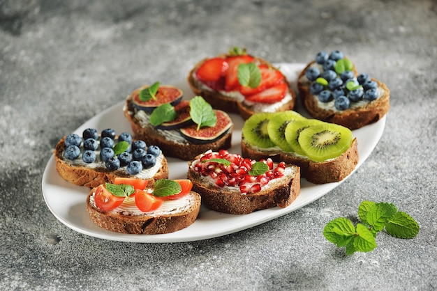 Vegetarian sandwiches from rye bread with soft cheese, and fruits