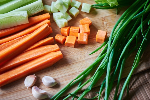 Vegetarian set of sliced carrots and cucumbers, garlic, green onion and lettuce