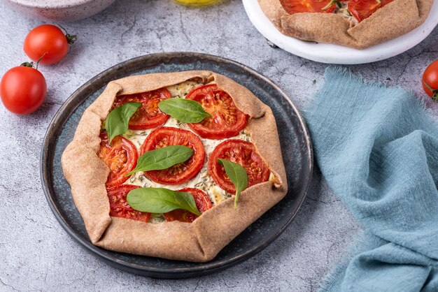 Vegetarian tart with tomatoes pizza galette with feta cheese and spinach