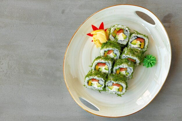 Vegeterian sushi roll with dill and vegetables on wooden background