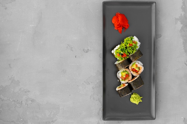 Vegeterian sushi roll with vegetables on gray background