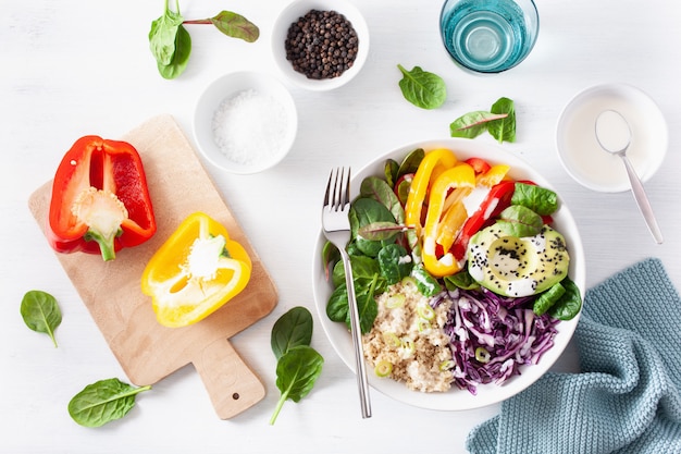 Veggie couscous lunch bowl with avocado, bell peppers, spinach and red cabbage