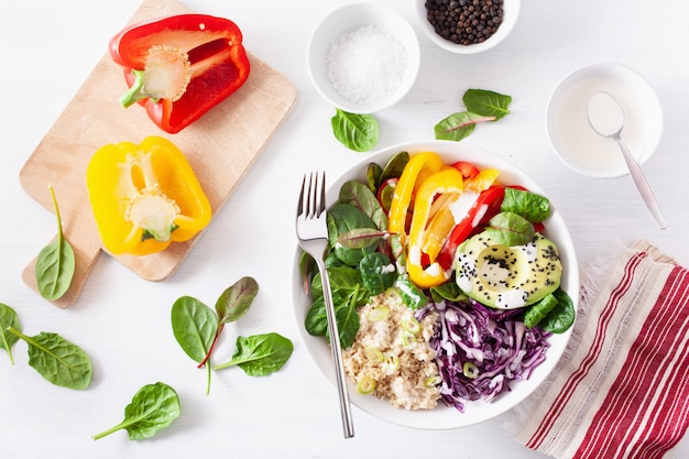 Veggie couscous lunch bowl with avocado, bell peppers, spinach and red cabbage