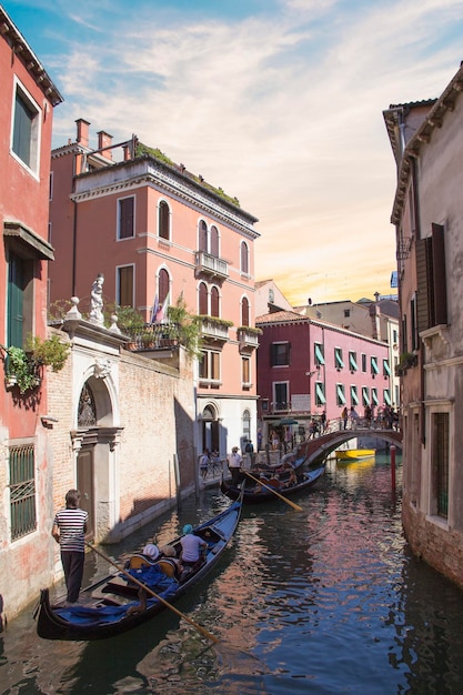 Venice - August 27 Gondolier drives a gondola with tourists on board on the Grand Canal on August 2