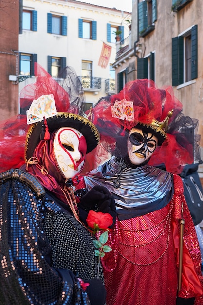 Venice Italy Couple in costumes and masks on the street during the Carnival