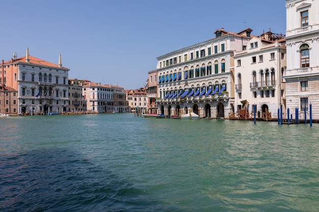 Venice, Italy - July 1, 2018: Panoramic view of Grand Canal (Canal Grande). It is a major water-traffic corridors in Venice city. Landscape of summer sunny day and blue sky