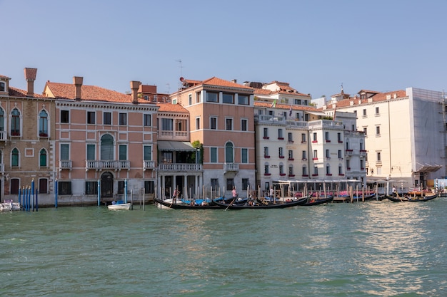 Venice, Italy - July 1, 2018: Panoramic view of Grand Canal (Canal Grande) with active traffic boats. It is a major water-traffic corridors in Venice city. Landscape of summer sunny day and blue sky