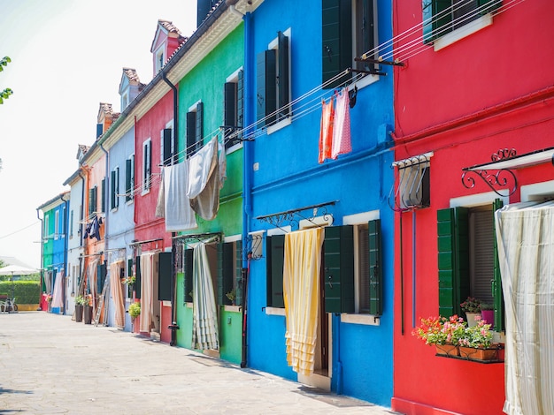 Venice landmark, Burano island canal, colorful houses and boats, Italy.