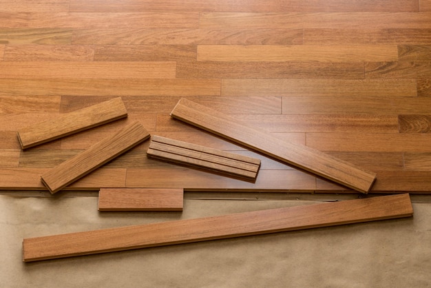 Vertical blinds cast shadows on a newly installed Brazilian Cherry hardwood floor with planks ready for laying