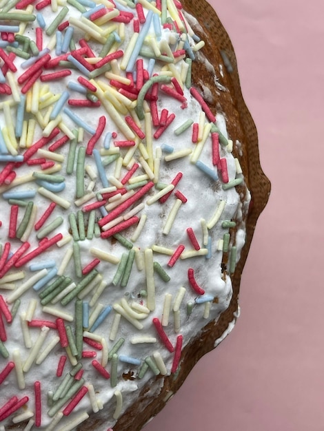 Vertical cropped shot of a delicious freshly baked paska easter cake on pink background