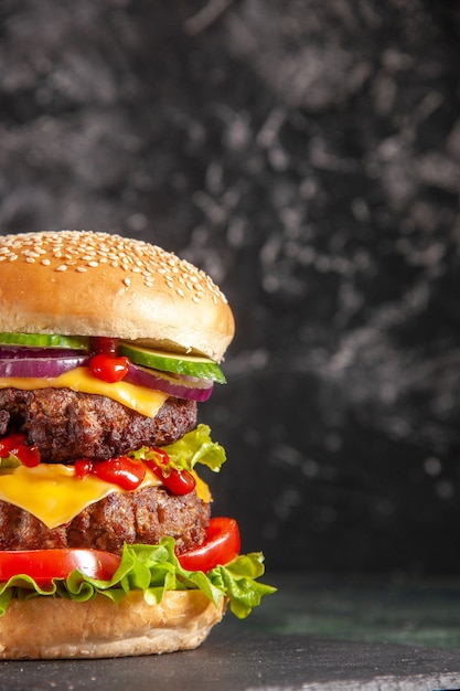 Vertical of delicious meat sandwich with tomatoes green on dark color tray on black surface