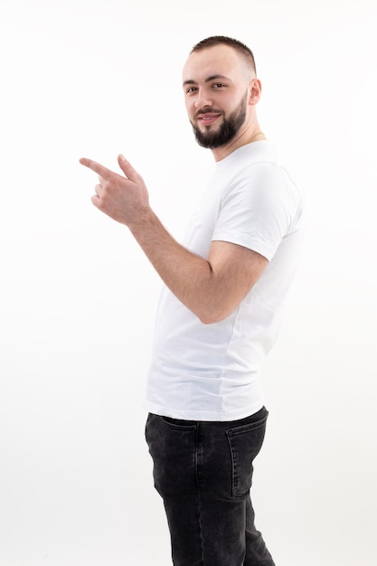 Vertical excited smiling man with mustache look at camera in casual outfit pointing presenting some