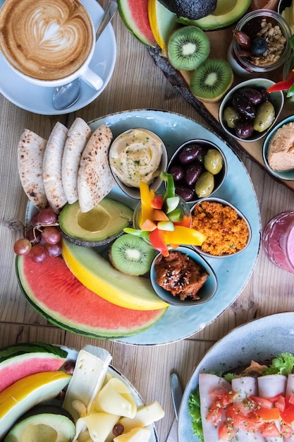 Vertical high angle shot of traditional Ethiopian food with fruits and vegetables on a table