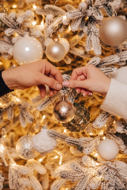 Vertical image lovely young romantic couple decorating Christmas tree