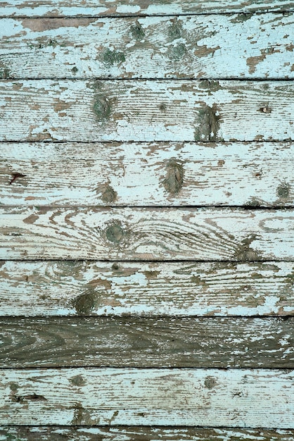 Vertical image of weathered wooden exterior wall of an old country house