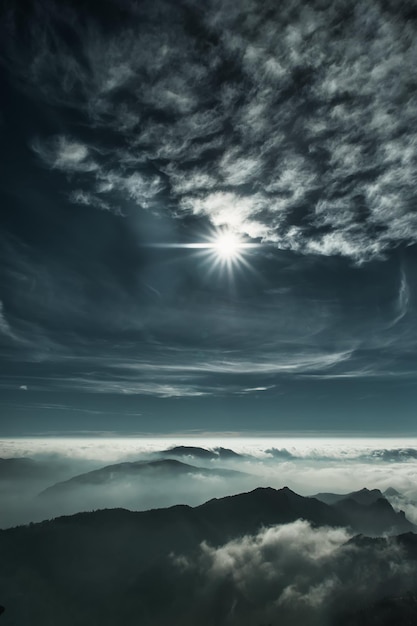 Vertical mountain landscape with fog and sunshine