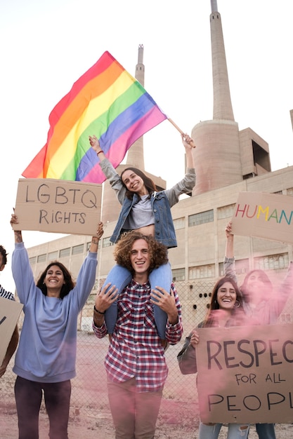 Vertical photo of cheerful gay pride and lgbt demonstration activist group os people supporting homo...