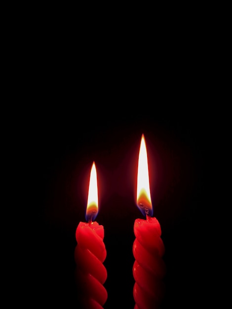 Vertical Photo of a Pair of Red Candle Burning On the Dark, with Free Space for Text or Design