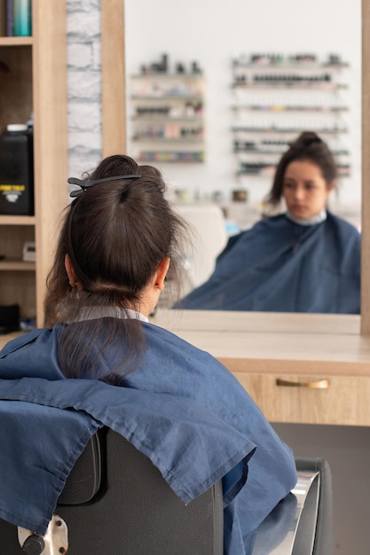 Vertical photo of woman ready and waiting to have her hair done at the beauty salon