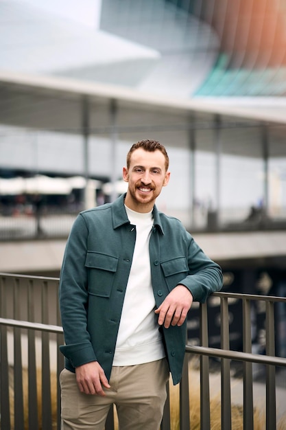 Vertical portrait of happy handsome smiling man looking at camera