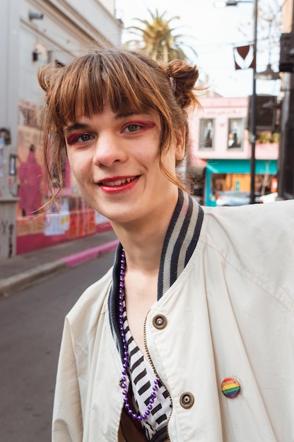 Vertical portrait for social networks of young transgender woman outdoors looking at the camera