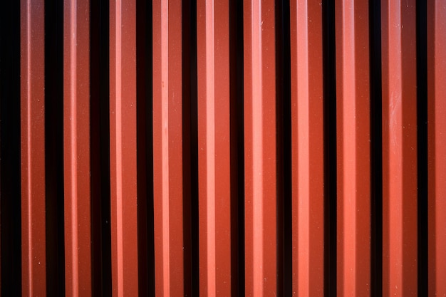 Vertical red fence illuminated by dramatic day light