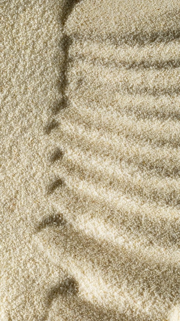 Vertical sandy light background format 916 with waves of sand macro