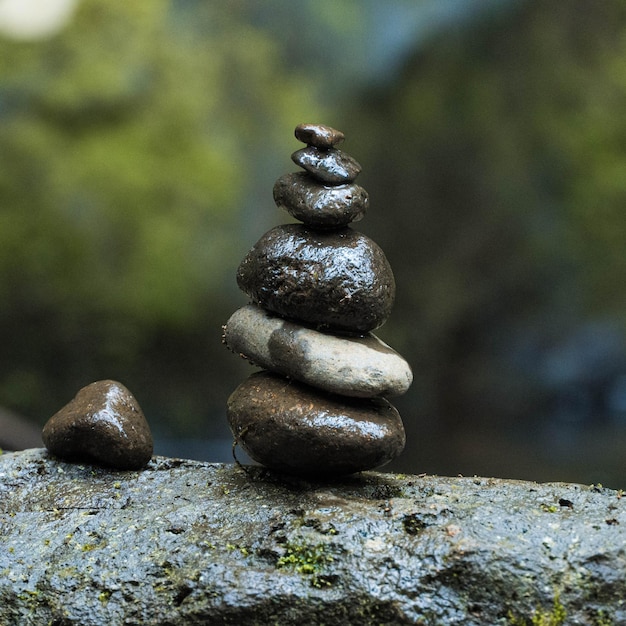 Vertical shot of balanced stones in a blurred background