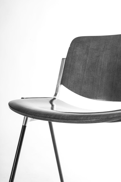 Vertical shot of a black corporate chair isolated on a white background