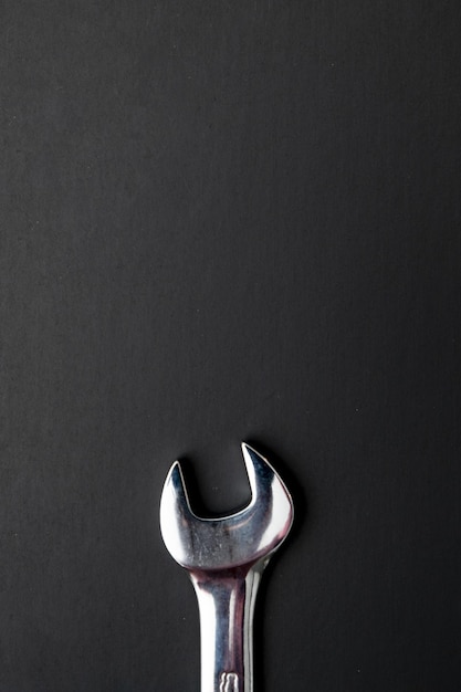 Vertical shot of a combination wrench on a black background