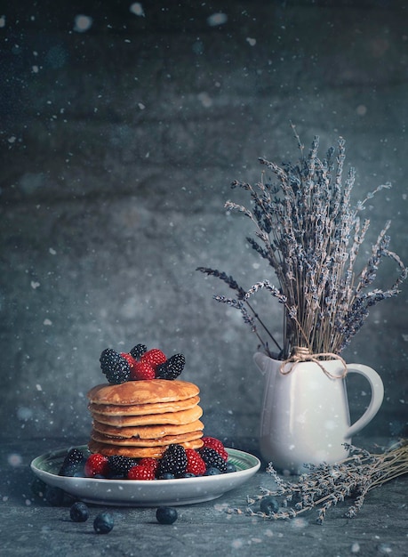 Vertical shot of a delicious breakfast with pancakes and berries