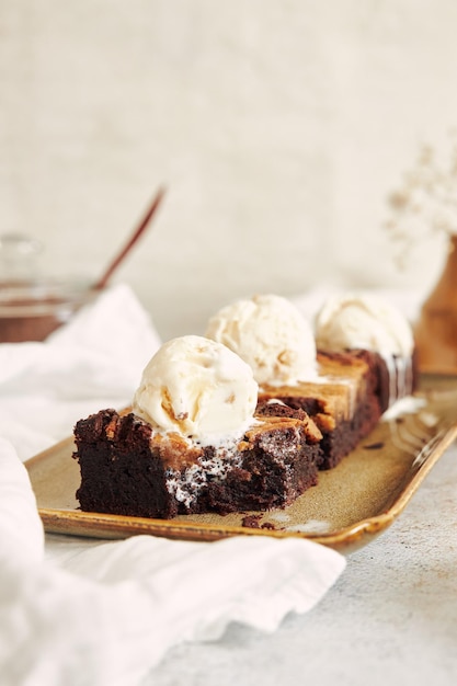 Vertical shot of delicious peanut butter swirl brownies with ice cream