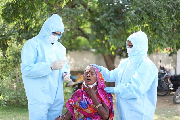 Vertical shot of  doctors who take COVID-19 test from the Indian woman