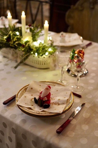 Vertical shot of a table set for Christmas with candles and decorations