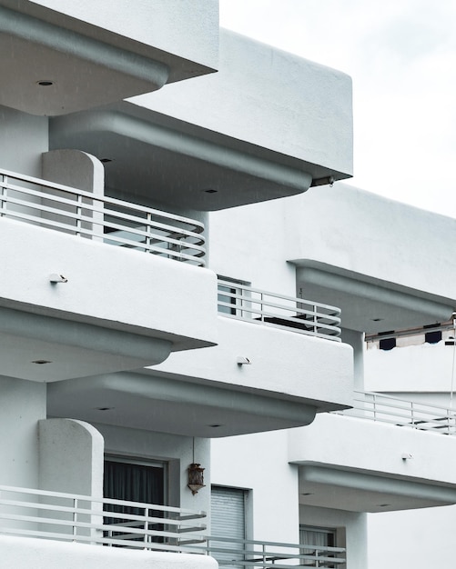 Vertical shot of the white building with several balconies